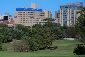 Trees and greenspace in foreground with Children's Hospital in background