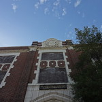 Looking up at the front of a brick building